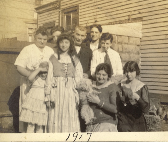 This the Spielmann family, 1917. One son--possibly Erwin--is missing from this picture. Leonor peeks out from behind Fanny. Photographer unknown.